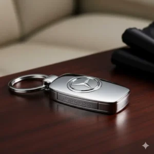 Elegant, silver-plated car keychain with a luxury car brand logo engraved on the pendant.