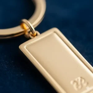 Close-up detail of a high-quality 14k gold plated keychain, highlighting the smooth finish and craftsmanship.