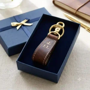 An elegant personalized leather key ring packaged neatly inside a luxury cardboard gift box